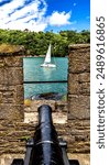 Colorful Cannon Castle Dartmouth Sailboat Devon England.  Castle originally built 1300s to protect harbor and River Dart. In 1400s castle expanded and iron chain to Kingswear to protect harbor.