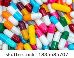 Colorful capsule pills. Pharmaceutical industry. Healthcare and medicine background. Pharmaceutics concept. Antibiotic drug resistance. Pink, white, orange, red, green, blue, and gray capsule pills.