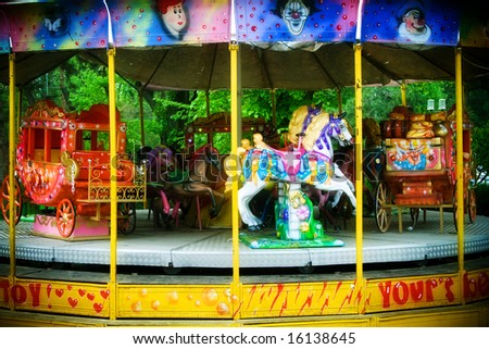 Colorful carousel with horses in theme-park
