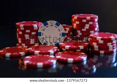 Colorful casino chips on table close up