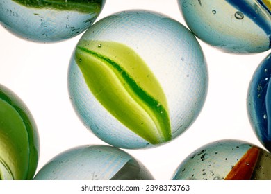 Colorful cats eye marbles on a white background. - Powered by Shutterstock