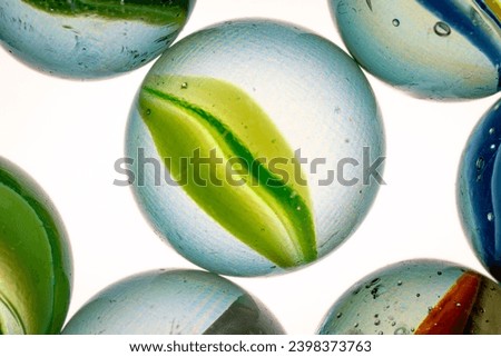 Colorful cats eye marbles on a white background.