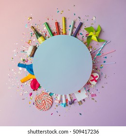 Colorful Celebration Background With Various Party Confetti, Balloons, Streamers, Fireworks And Decoration On Pink Background. Flat Lay.