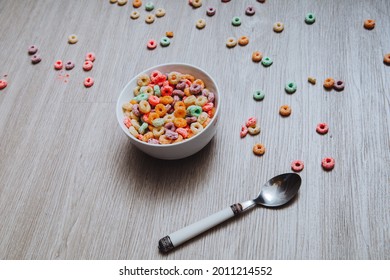 Colorful Cereal  In A Bowl With Spoon On The Floor.