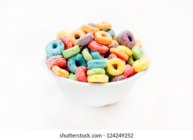 Colorful cereal in white bowl on white background