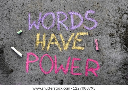 Colorful chalk drawing on asphalt: text WORDS HAVE POWER