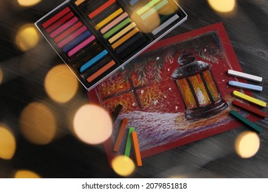 Colorful chalk pastels   beautiful painting black wooden table  above view  Bokeh effect