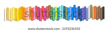 Colorful chalk pastels in an Up and Down Pattern, on white background, arranged as rainbow spectrum 