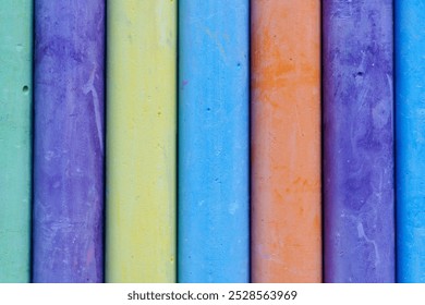 Colorful chalk sticks arranged in a row, showcasing vibrant hues. Ideal for art projects, educational activities, and creative play in classrooms or at home. - Powered by Shutterstock