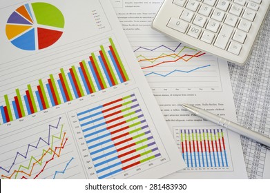 Colorful Charts And Spreadsheet With Calculator And Pen