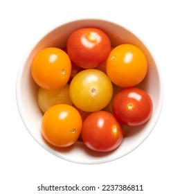 Colorful cherry tomatoes in a white bowl. Fresh, ripe type of small and round cocktail tomatoes, of red, yellow and orange color. Solanum lycopersicum var. cerasiforme. Isolated, close up, from above.