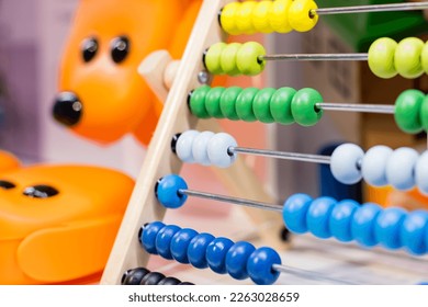 Colorful children's abacus on the table. Mathematics, arithmetic for preschool and school children, learning to count. wooden abacus with multicolored knuckles - Shutterstock ID 2263028659