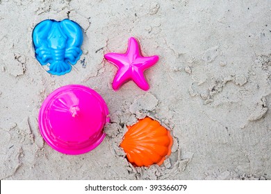 Colorful Children's Beach Toys On Sand, Top View