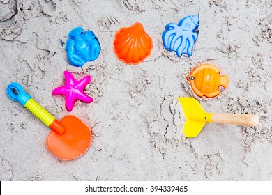 Colorful Children's Beach Toys On Sand, Top View