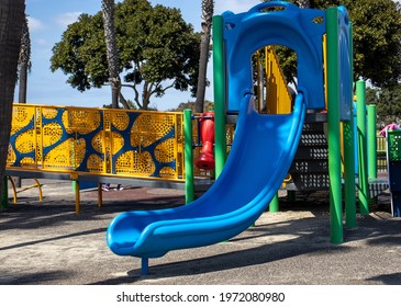 A colorful children's play set at a public park.