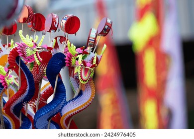 Colorful Chinese dragon toys in Chinese New Year festival.Chinese New Year Decoration, Dragon toy paper on festive background. - Powered by Shutterstock