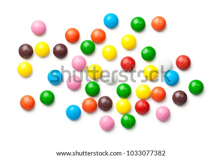 Colorful chocolate candy pills isolated on white background. Top view