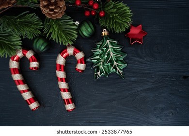 Colorful Christmas decorations with candy canes, shiny ornaments, and a beautifully wrapped gift in red ribbon - Powered by Shutterstock