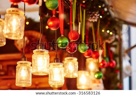 Colorful Christmas decorations and glass lanterns on a Parisian Christmas market