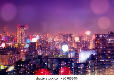Colorful City Buildings Nightlife Background Decorated With De-focus Bokeh Lights Reflecting From The Buildings And Purple Filter. The Dense Asian-style Buildings Were Taken In Tokyo, Japan.