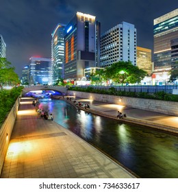 Colorful city lights of Cheonggyecheon Stream Park with Crowd at night in Seoul City, South Korea. 