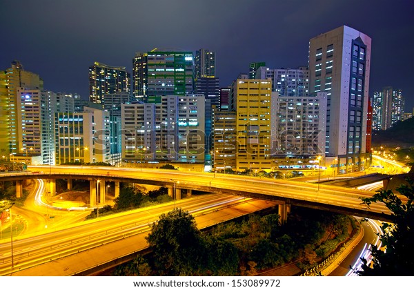 Colorful city night\
with buildings and\
bridge