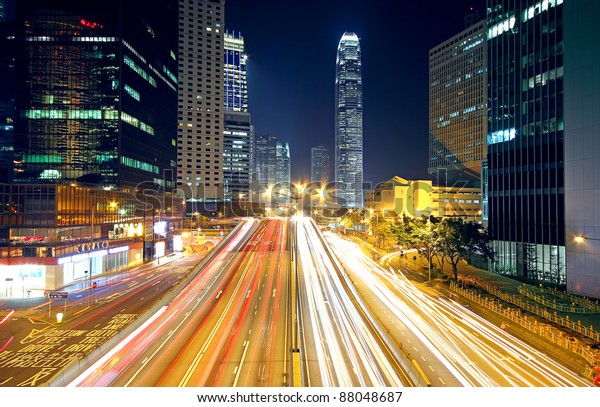 Colorful city night with lights of cars motion\
blurred in hong kong