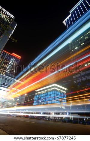Colorful city night scene with cars motion blurred with skyscrapers in Taipei, Taiwan.