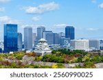 Colorful cityscape of Osaka castle and Osaka city in autumn season with white cloud and blue sky background, Japan. Top view. Landmark of Osaka.