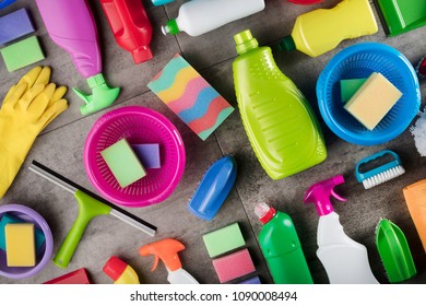 Colorful Cleaning Products On Gray Tiles. Top View.