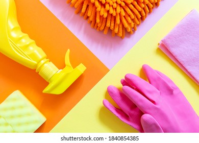 Colorful cleaning set of tools on the bright background. Yellow spray, pink gloves, orange rag. Housekeeping and cleaning the house concept - Powered by Shutterstock