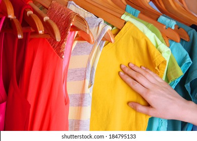 Colorful Clothes Hanging In Wardrobe