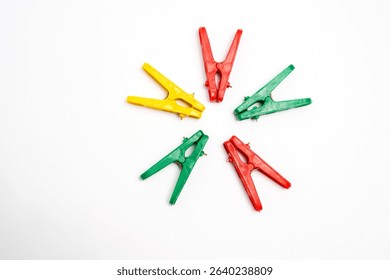 Colorful Clothespins Arranged in Circle on White Background