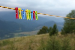 Colorful Clothespins Hanging On Washing Line In Mountains
