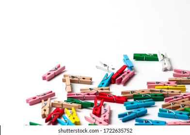 Colorful clothespins on awhite background with place for text.
