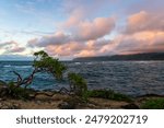 Colorful clouds drift over the north shore of Oahu at Laie Point, Hawaii.