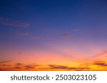 Colorful clouds and sky. Dusk and sunset. Evening clouds with orange, yellow, pink and red sunlight and amazing storm clouds in the dusk sky.