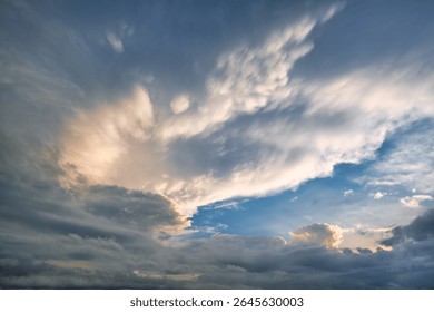 Colorful clouds at sunset create a dramatic sky view above a tranquil horizon filled with warm hues and soft shadows