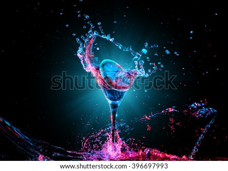 colorful cocktail in glass with splashes and lemon on dark background. Party club entertainment. Mixed light