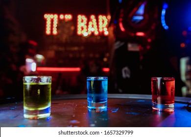 Colorful cocktails at the bar. Colorful shots at the club. Alcoholic drink in different colors. Nightlife scene. Shots at the bar table. - Powered by Shutterstock