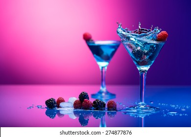 Colorful cocktails garnished with berries