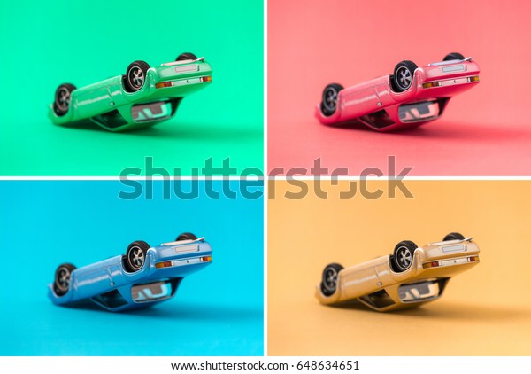 Colorful collection of retro toy car model\
accident in overturned composition with side view on colorful\
background. Green, Red, Blue, Yellow. traveling and accident and\
transport concept.