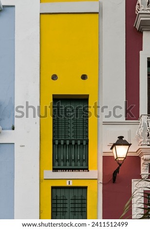 colorful colonial houses on calle tetuan in old san juan, puerto rico including the world's narrowest yellow building (the narrow house or la casa estrecha) buildings spanish architecture details