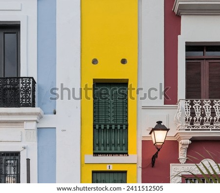 colorful colonial houses on calle tetuan in old san juan, puerto rico including the world's narrowest yellow building (the narrow house or la casa estrecha) buildings spanish architecture details