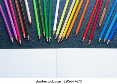 Colorful Colored Pencils And Open Sketchbook. Flat Lay, Copy Space