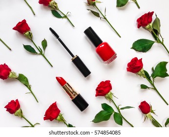 Colorful composition with red bright roses, cosmetics, woman accessories. Flat lay on white table, top view