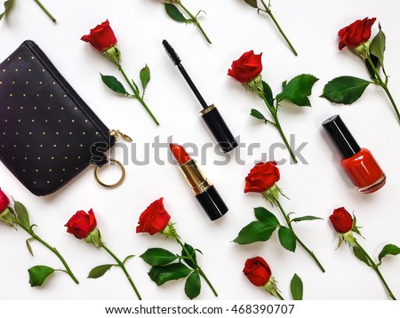 Colorful composition with red bright roses, purse and woman accessories. Flat lay on white table, top view