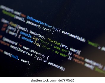 Colorful computer code language on the computer screen. Email, password and error text emphasized on the screen. Image taken in an angle