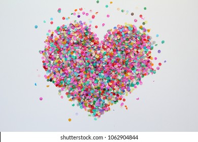 Colorful confetti in the form of a heart on a white background. Background, texture. - Powered by Shutterstock