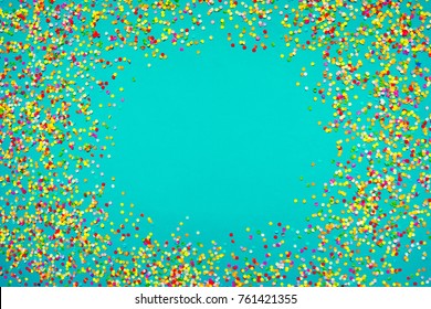 Colorful Confetti in front of blue Background. 